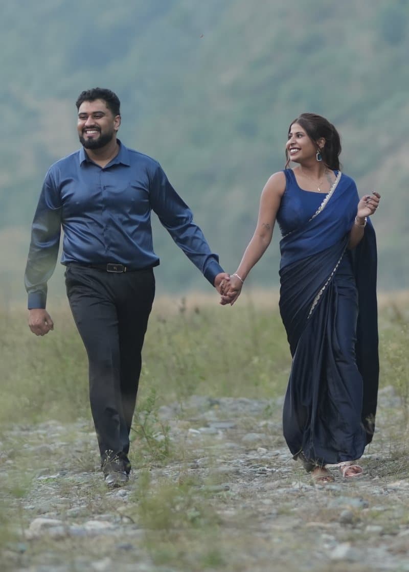 Samriti and Sarthak walking hand in hand through the valley